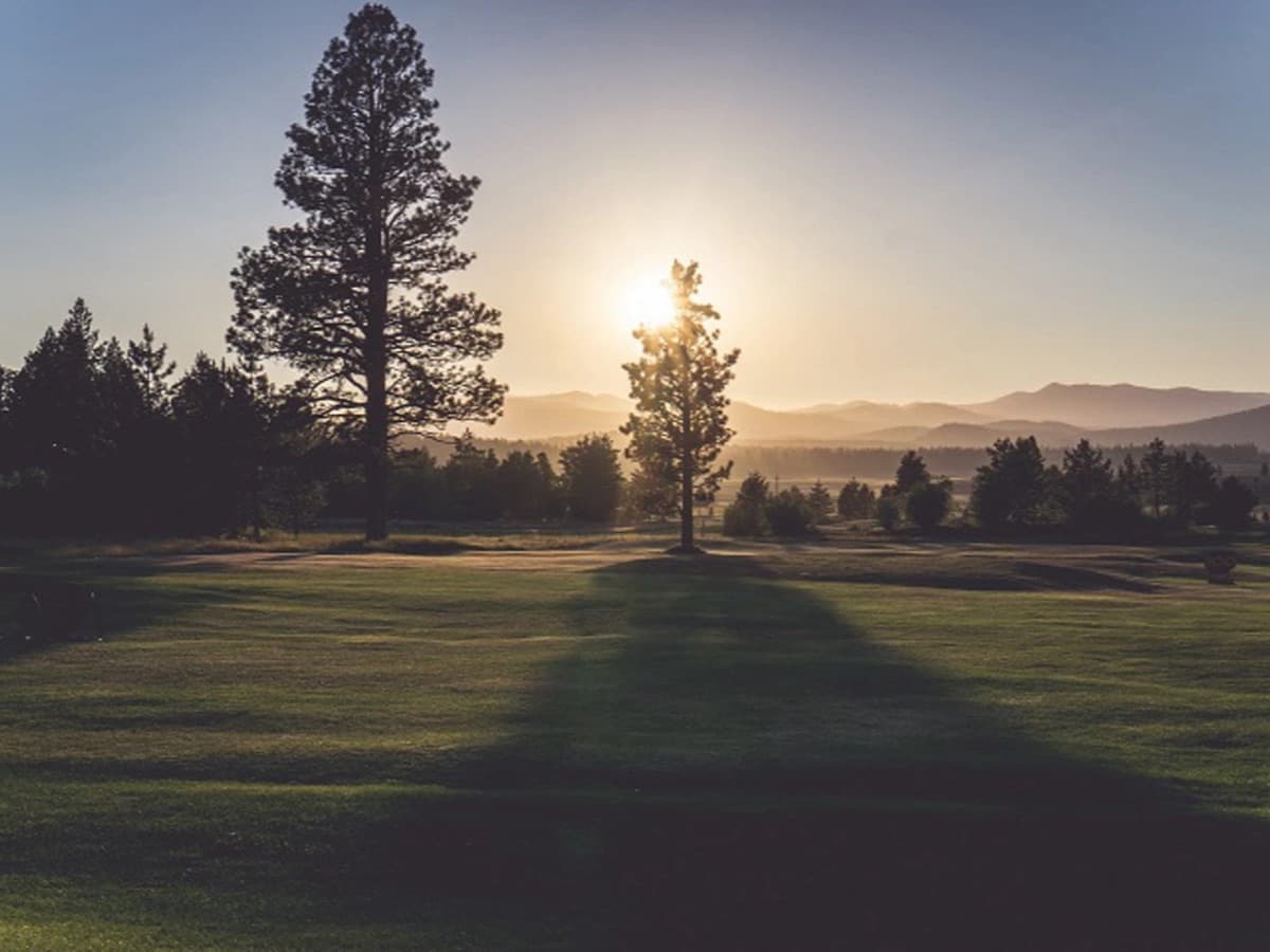 Fairway at Northstar Golf Course at sunset with Martis Valley and the Sierra beyond